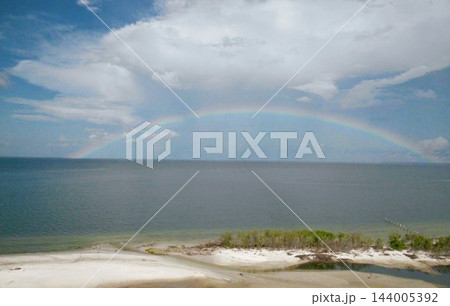 A Rainbow over The Beach in Fort Myers Beach Florida USA A Rainbow over The Beach in Fort Myers Beach Florida USA 144005392