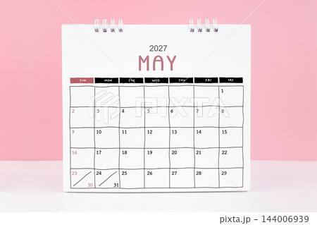 Desk calendar for May 2027 on a pink color background with copy space. Desk calendar for May 2027 on a pink color background with copy space. 144006939