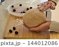 Hands Shaping Homemade Whole Wheat Bread Dough 144012086
