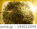 Preparing CBD Infused Butter with Dried Cannabis Herbs 144012094