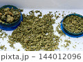 Ground Cannabis Buds and Herbal Marijuana in Grinders 144012096