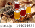 Black and green tea in small glass cups. 144034624
