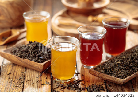 Black and green tea in small glass cups. Black and green tea in small glass cups. 144034625