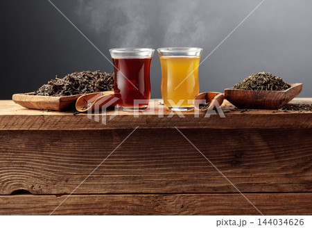 Black and green tea on an old wooden table. Black and green tea on an old wooden table. 144034626