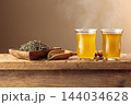 Green tea in small glass cups on an old wooden table. 144034628