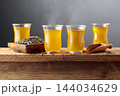 Green tea in small glass cups on an old wooden table. 144034629