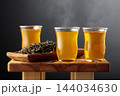 Green tea in small glass cups on an old wooden table. 144034630