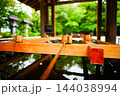神社の手水舎に並ぶ柄杓と清らかな水 144038994