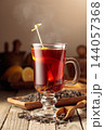 Black tea with lemon on a wooden table. 144057368