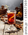 Black tea with lemon on a wooden table. 144057369