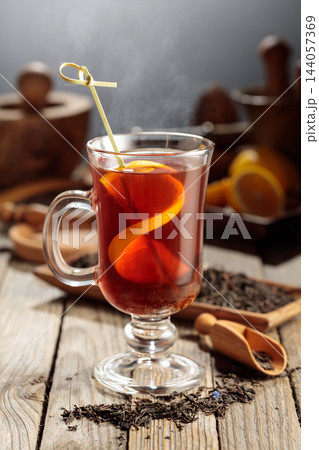 Black tea with lemon on a wooden table. Black tea with lemon on a wooden table. 144057369