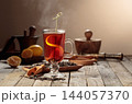 Black tea with lemon on an old wooden table. 144057370