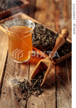 Green tea on an old wooden table. 144057373