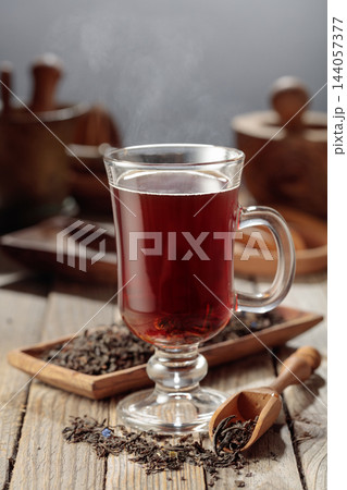 Black tea on a wooden table. 144057377
