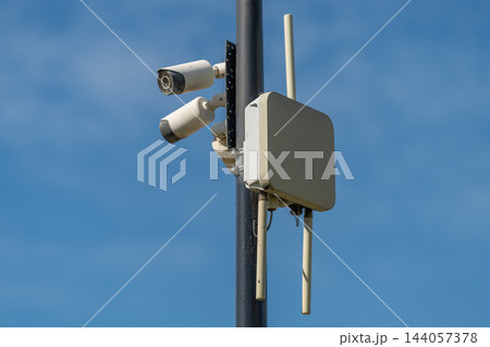 Security cameras and wireless equipment against a blue sky 144057378