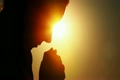 Silhouette of woman head, holding two fists together and bowed head, after rises head up 3510147