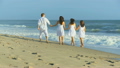 Caucasian Parents Teenage Girls Walking Together Beach 9907940