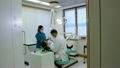 Dentist and assistant checking dental hygiene of female client. Sequence of steadicam shots 13781536