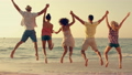Group of friends jumping together on the beach 16480037