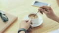 Cinemagraph of person mixing sugar in coffee cup 21906125