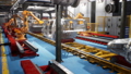 Car welding line of conveyor with frameworks of unfinished cars and robots welders 46492603