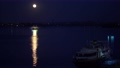 The ship floats on the river at night. The moon is shining. On the water the lunar path. 59560431
