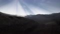 Sun Rays over Mountains in a Valley 60977767
