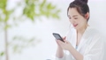 座ってスマホを操作する女性 61486793