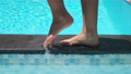 Female feet walking on pool border 67787037