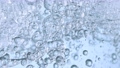 Super Slow Motion Shot of Moving Oil Bubbles in Water on Light Blue Background at 1000fps. 70604272