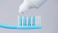 Toothpaste on toothbrush on white background 71161789