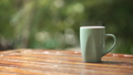 Hot coffee cup with smoke on wood table top in bokeh green nature background  71678588