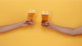 Hands of two friends raising and clanging glasses of beer  71678592