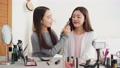 Asian woman influencers doing cosmetic makeup tutorial online live streaming 71680803