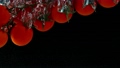 Super Slow Motion Shot of Falling Cherry Tomatoes into Water at 1000fps. 72084971