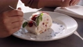 Dessert time. Close up shot of woman eating tasty cake with berries in cafe, slow motion 73361805