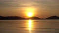 Dramatic sea sunset or sunrise Burning golden sky and shining golden waves Beautiful light reflection on sea surface Amazing landscape or seascape 4-K footage 77745054
