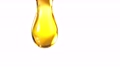 Super Slow Motion Macro Shot of Dripping Oil Isolated on White Background at 1000 fps. 78544442