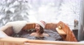 Woman relaxing in hot bath at snowy mountains 85628470
