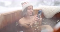Woman relaxing in hot bath at snowy mountains 85628490