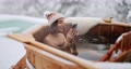 Woman relaxing in hot bath at snowy mountains 85628497
