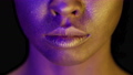 Closeup Of Female Mouth With Golden Skin Over Black Background 85879365