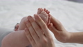 Mother Care Concept. Loving Mom Touching Tiny Legs Of Her Newborn Baby 85881792