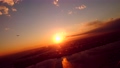 日没直前の羽田空港を夕日を浴びて離陸する飛行機から見えるマジックアワーの東京の風景 86379307