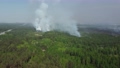 Large smoke clouds and fire spread. Aerial view of smoking wild fire 86588164