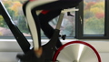 Exercise bike with spinning wheels. Woman exercising at home on spin indoor bicycle doing fitness workout. Woman training on stationary bike watching online video class for cardio 86770364