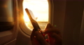 Phone close up of woman hands using mobile phone sitting in airplane. Sunset and flare in window seat. Smatphone concept in plane 86770376