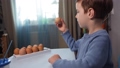 A little child paints an easter egg. 87236533