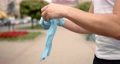 Cropped view of man putting on gloves outdoors 87892530
