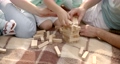 Young family playing jenga on plaid at the river 87892843
